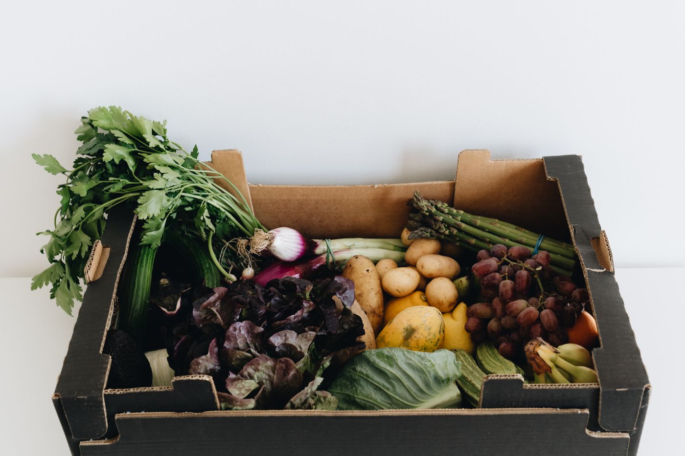 A box filled with fresh seasonal fruits and vegetables